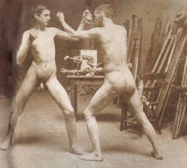 Two nude boys boxing in atelier