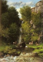 Une famille de cerfs dans un paysage avec une cascade